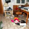 view of kitchen/livingroom area after it has been trashed by investigators